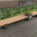 Wooden Outdoor Landscape Bench With Green Plants Brick Wall And Trash Bin On Stone Pavement