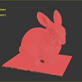 Brown Rabbit Sculpture Sitting On Gray Pad With Detailed Ears And Eyes