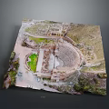 Aerial View Of Ancient Amphitheater Ruins With Green Grass And Historical Landscape