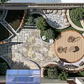 Garden Courtyard Design With Circular Wooden Patio Irregular Stone Paving And Greenery Surroundings