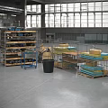 Industrial Equipment In Large Warehouse With Metal Shelves Blue Carts Pallets And Stacked Crates