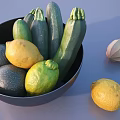 Fresh Zucchini and Lemons in Black Bowl with Wooden Juicer and Extra Lemon