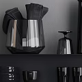 Black Ceramic Vessels on Black Shelves Including Vases Cups Plates Bowls and Goblets
