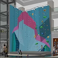 Indoor Climbing Wall With Colorful Holds In Shopping Mall People Climbing And Watching