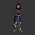 Woman Sitting On White Chair In Gray Top Blue Jeans Holding Phone Against Gray Background