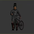 Man in Checkered Racing Suit Standing with Mountain Bicycle and Helmet