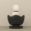 Decorative Lamp with White Spherical Shade and Black Petal Shaped Base in Modern Minimalist Design