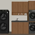 Stacked Front Loading Washing Machines In Laundry Room With Wooden Cabinets Sink And Countertop