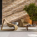 Woven Outdoor Chairs With Stone Wall Green Plant Small Table And Rug