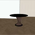 Modern Round Black Dining Table With Unique Twisted Base On Light Wooden Floor And Shadows