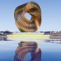 Spiral Golden Striped Sculpture With White Base And Water Reflection Against Blue Sky Mountain Backdrop