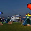 Outdoor Camping Event With Lighted Tents Food Truck And Decorative Umbrella Lights On Grass