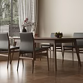 Wooden Dining Table Set with Gray Upholstered Chairs Vase Flowers Fruit Bowl and Natural Light