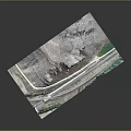 Aerial View Of Natural Mountainous Terrain With Winding Road Rock Formations And Green Vegetation