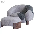 Plush Orange Lounge Chair With Matching Ottoman Blue Throw Blanket And Wooden Legs