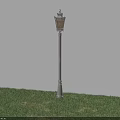 Outdoor Street Lamp with White Post Illuminated Warm Yellow Light on Grassy Ground Against Wall