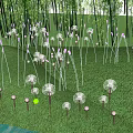 Dandelion Shaped Outdoor Lights with White Glow on Green Grass and Water Reflections at Night