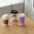 Three Refreshing Beverages with White Black Lids Purple Drink and Sprinkles on Wooden Table