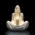 White Ceramic Hooded Figure Sculpture With Seated Pose And Lit Candle