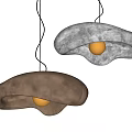 Modern Artistic Pendant Lights in Gold and White with Irregular Metallic Shapes Glowing Brightly
