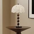White Floral Patterned Table Lamp With Wooden Spherical Base On Round Brown Side Table