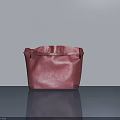 Red Leather Handbag Placed On Gray Surface With Smooth Gray Background Wall