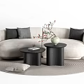 Beige Sofa with Black Gray Cushions and Black Round Coffee Tables Set Featuring Green Vase Red Berries on Gray Round Rug
