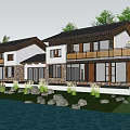 Waterfront Homestay Building With Stone Walls Black Roof White Walls And Palm Trees