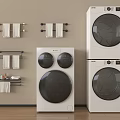 Modern White Front Loading Washing Machines In Organized Laundry Room With Towel Racks