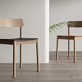 Simple Design Wooden Dining Chairs With Black Brown Seats And Green Plant In Light Space