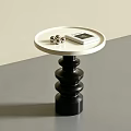 Modern Round Side Table With White Top Black Spiral Base Metal Balls And Magazine