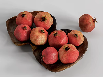 Fresh Ripe Pomegranates In Heart Shaped Wooden Bowl And One Extra On White Background 3d model