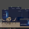 Blue Exhibition Booth With Display Panels Round Table White Chairs And Reception Desk