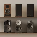 Various Design Speakers Collection Displayed On Wooden Shelf With Different Styles