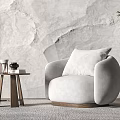 Light Gray Round Armchair With Side Table Decorative Items And Textured Wall 3d model