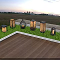 Outdoor Lights With Various Designs On Grass Near Wooden Deck At Twilight