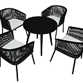 Black Round Table With Four Rattan Chairs And Light Colored Cushions Set