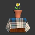 Small White Flower Plant in Orange Pot on Wooden Table with Blue Green Checkered Tablecloth