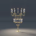 Golden Metal Candle Holders With Multiple Arms And Floral Decorations In Dark Background