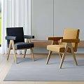 Black And Yellow Accent Chairs With Wooden Legs In Indoor Space With Curtains And Rug