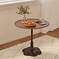 Round Wooden Side Table with Black Base Vase Green Plants Bowl Oranges and Tray