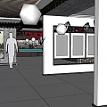 Indoor Exhibition Space with Display Cases Silhouette Figure Hanging Lights and Decorative Paintings