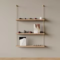 Wooden Wall Shelves With Three Tiers Teapots Teacups Decorations And Books On Beige Wall