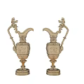 Pair of Ornate Golden Decorative Pitchers With Intricate Carvings And Sculpted Handles