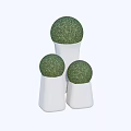 Small Garden Decor With Three White Cylindrical Bases And Green Spherical Plants