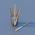 Gold And White Chopsticks In Transparent Glass Holder For Kitchen Utensils