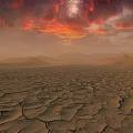 Dry Cracked Land Scenery With Red Orange Clouds And Distant Mountains At Sunset
