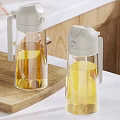 Transparent Condiment Bottles With Grey Lids On Wooden Cutting Board Kitchen Countertop With Lemons