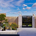 Garden Landscape With Wooden Fence Black Iron Gate Potted Plants And Stones Under Blue Sky