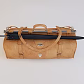 Brown Leather Travel Bag with Black Umbrella Handle and Metal Buckles